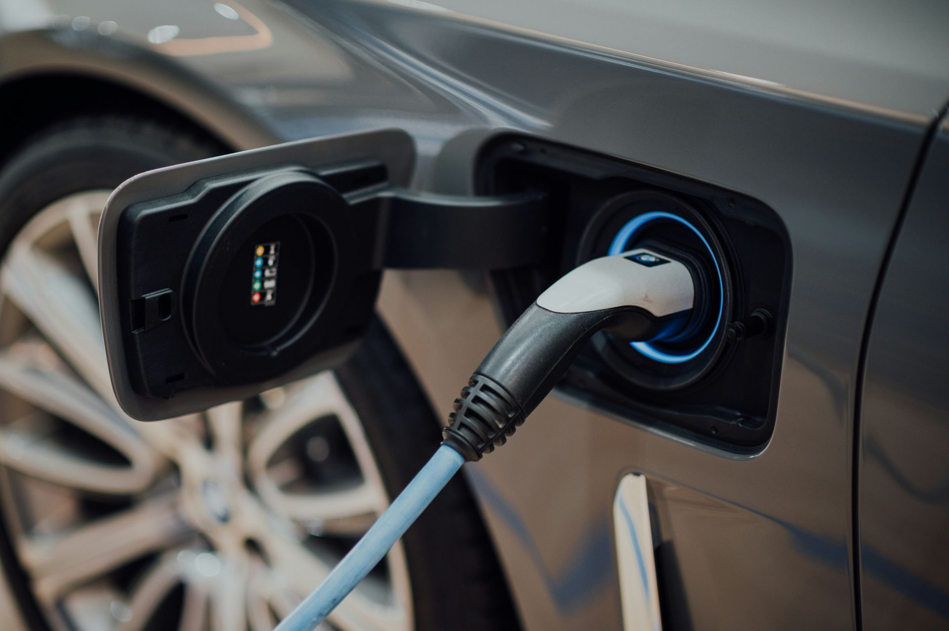 electric vehicle charging cable plugged into car